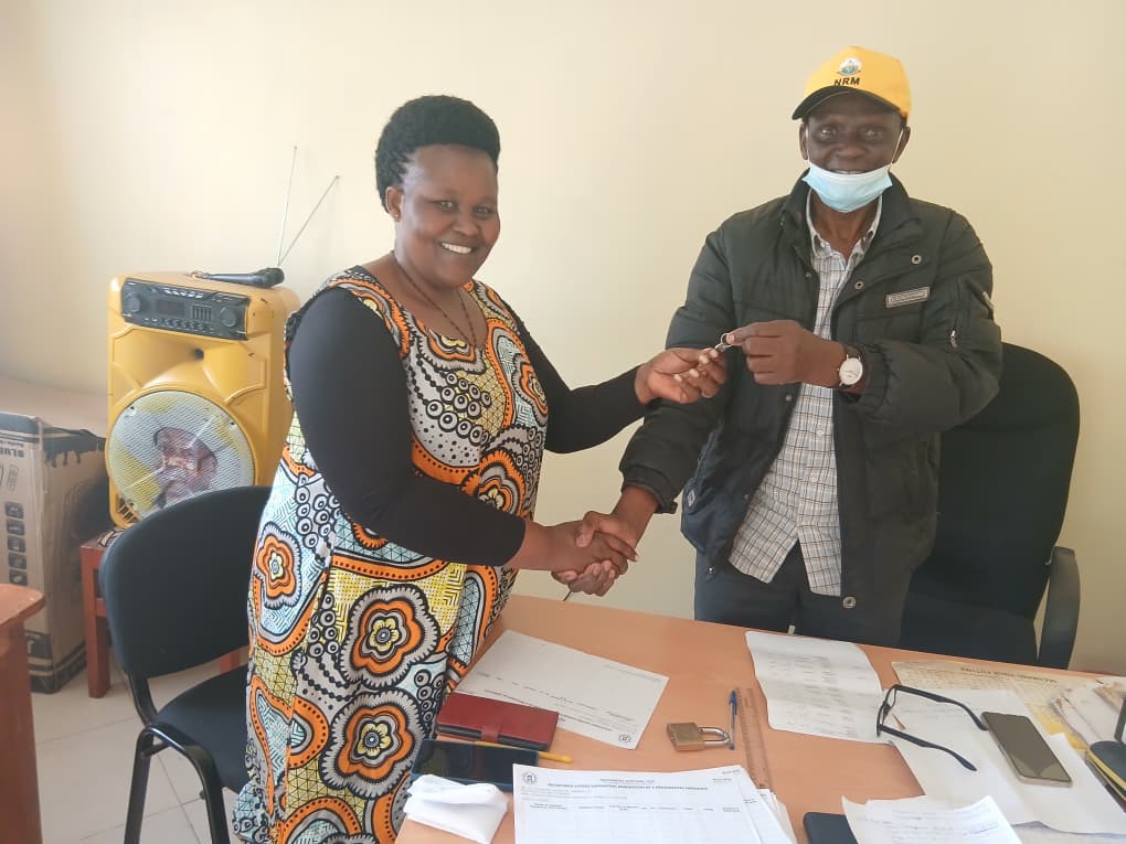 NRM'S office administrative Secretary Amos Rwansheija officially hands over the district Party office located along Kabale –Kisoro Road in Kabale town to the district’s party vice CP Bridget Asinga