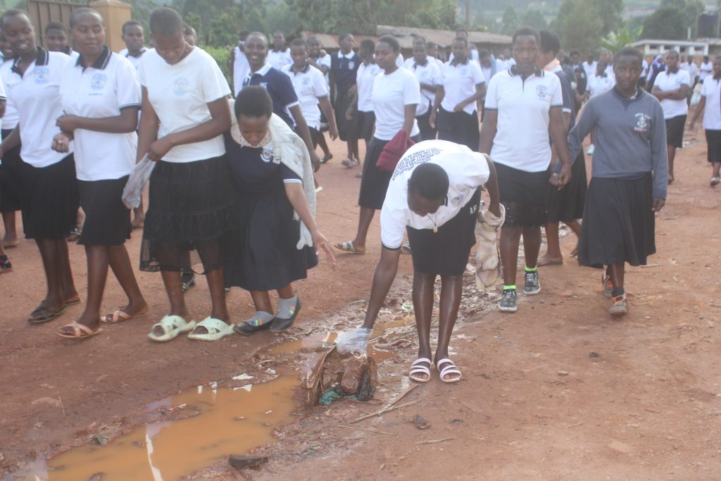 Students of St. Theresa Girls’ Vocational S.S Rushoroza PICK polythene bags along Mwanjari Market located on Kabale-Katuna road as Uganda commemorated its 63rd independence anniversary.