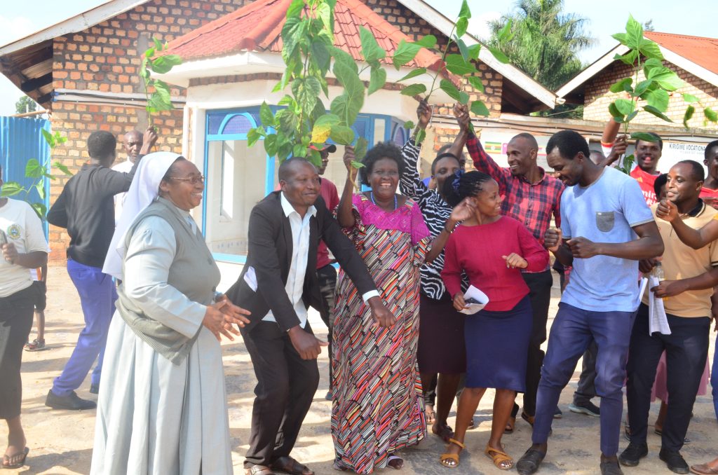 Sr Margaret Tusiime, the Headteacher of Bishop Asili Memorial Nursery and Primary School, celebrates with members of staff shortly after the 2025 PLE results were released by UNEB